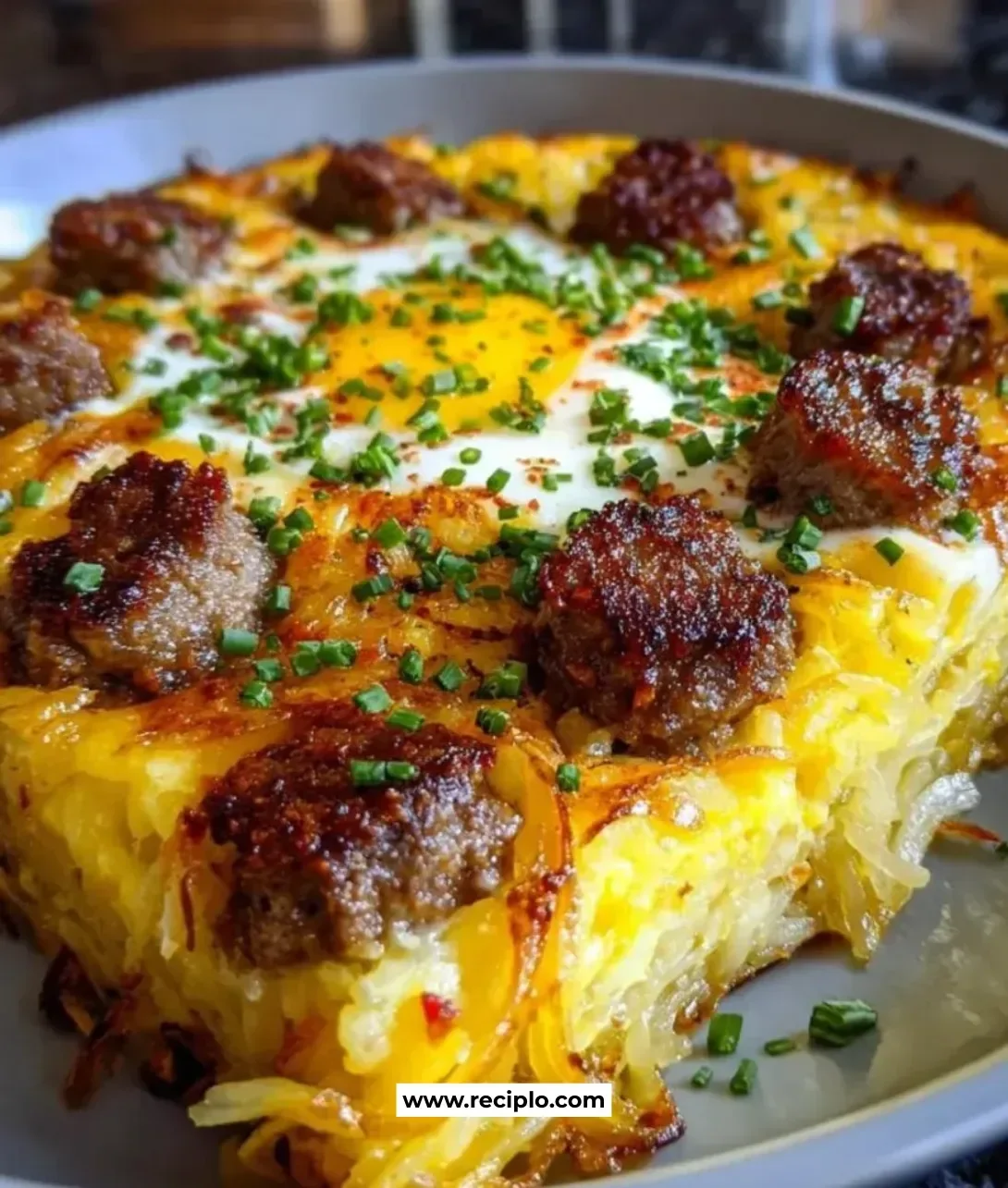 Sausage Hashbrown breakfast dish served with eggs and herbs
