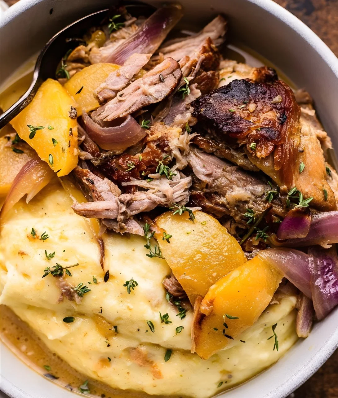 Delicious apple cider braised pork shoulder served with autumn vegetables.