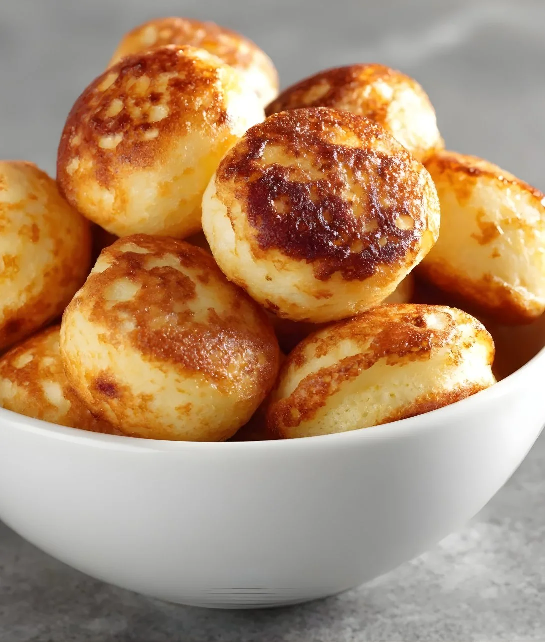 Delicious breakfast pancake poppers served with syrup and berries