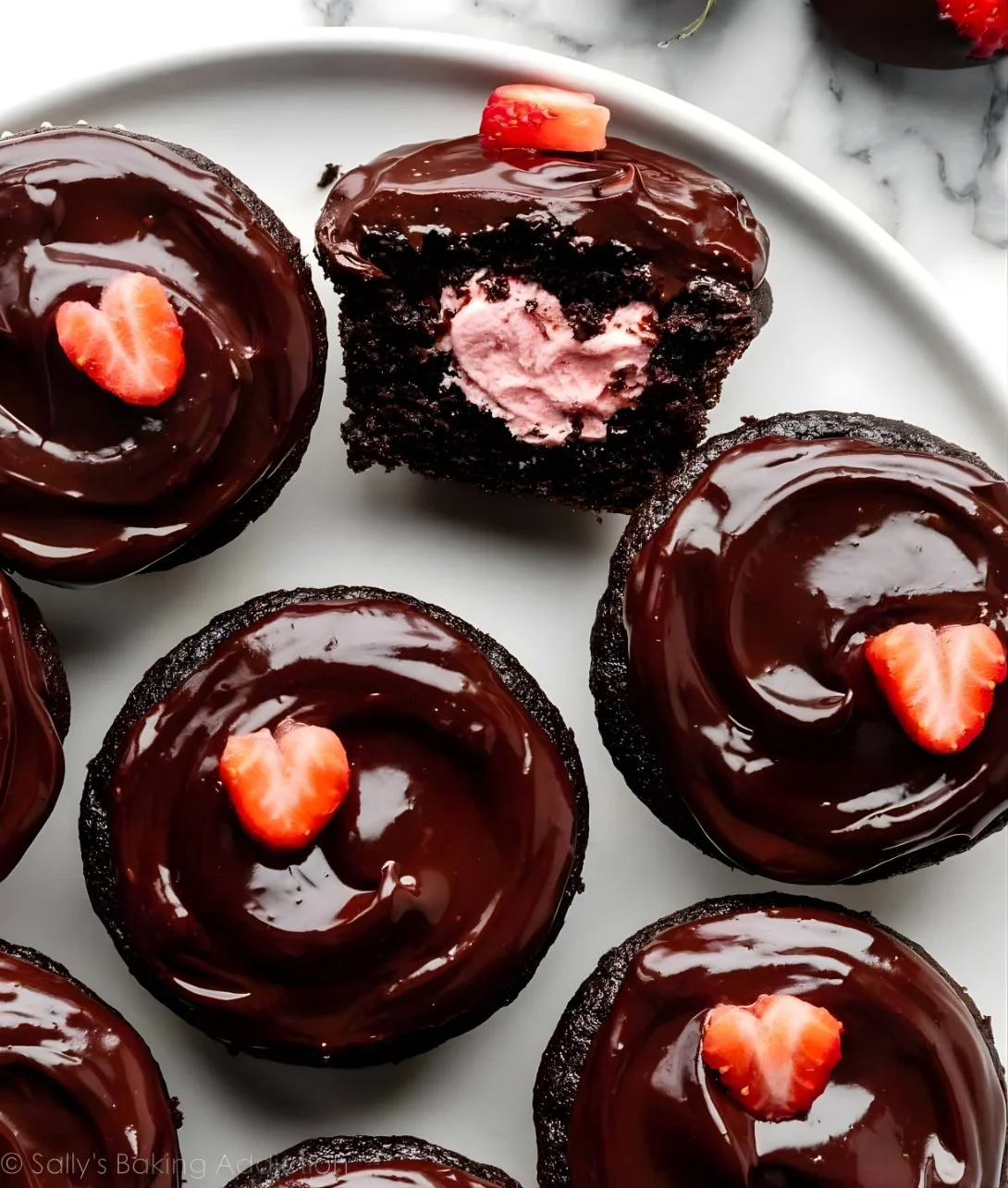 Delicious Chocolate Covered Strawberry Cupcakes topped with fresh strawberries