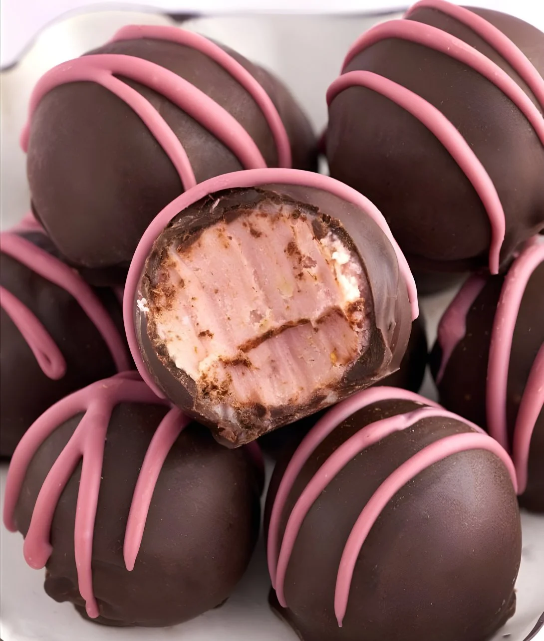 Delicious chocolate truffles filled with raspberry, a sweet gourmet treat