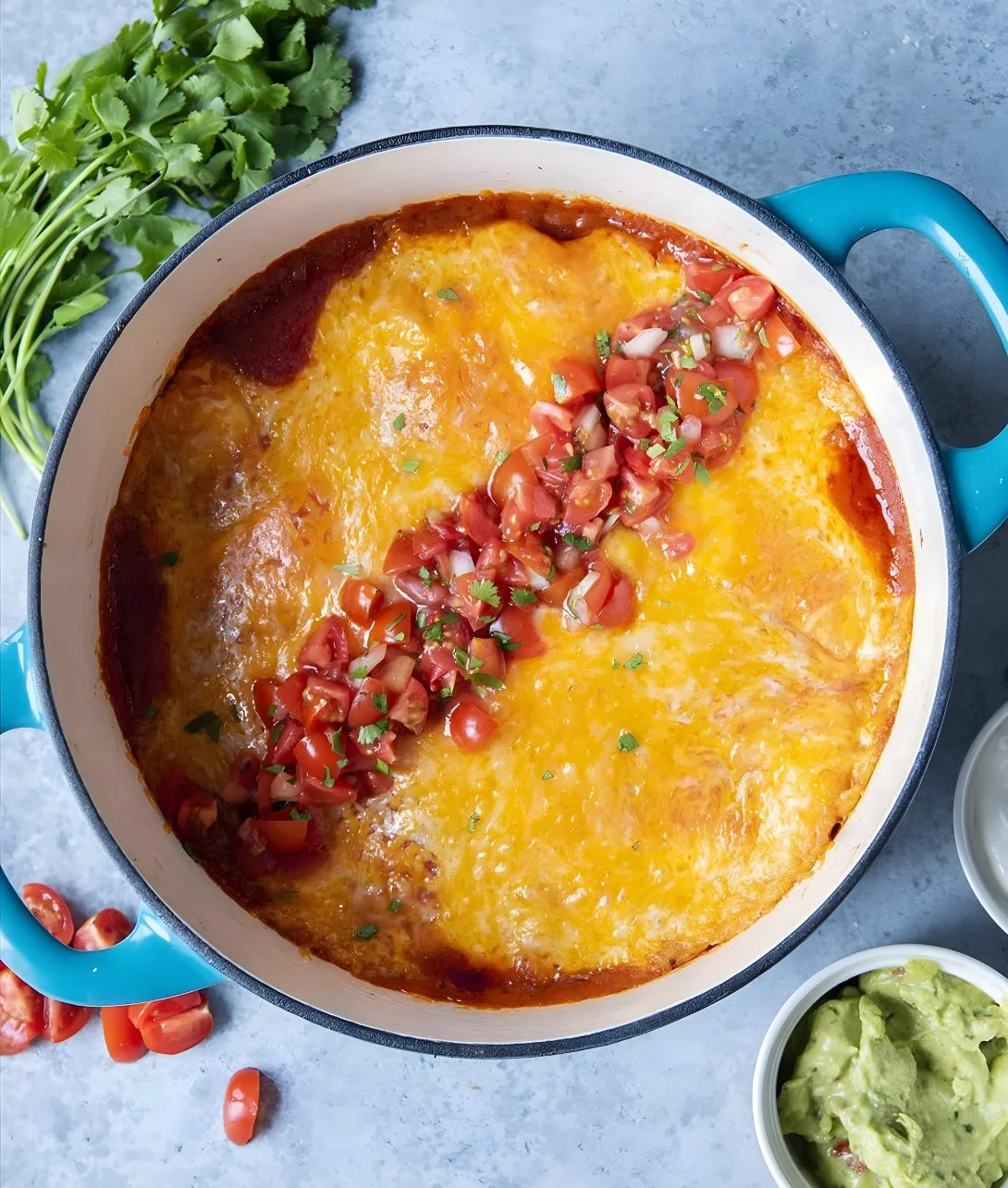 Dutch Oven Beef Enchilada Casserole with melted cheese and toppings