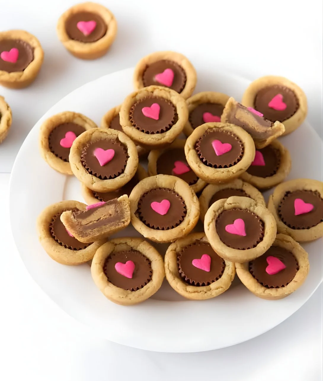 Delicious Valentine's Cookie Cups filled with frosting and heart sprinkles