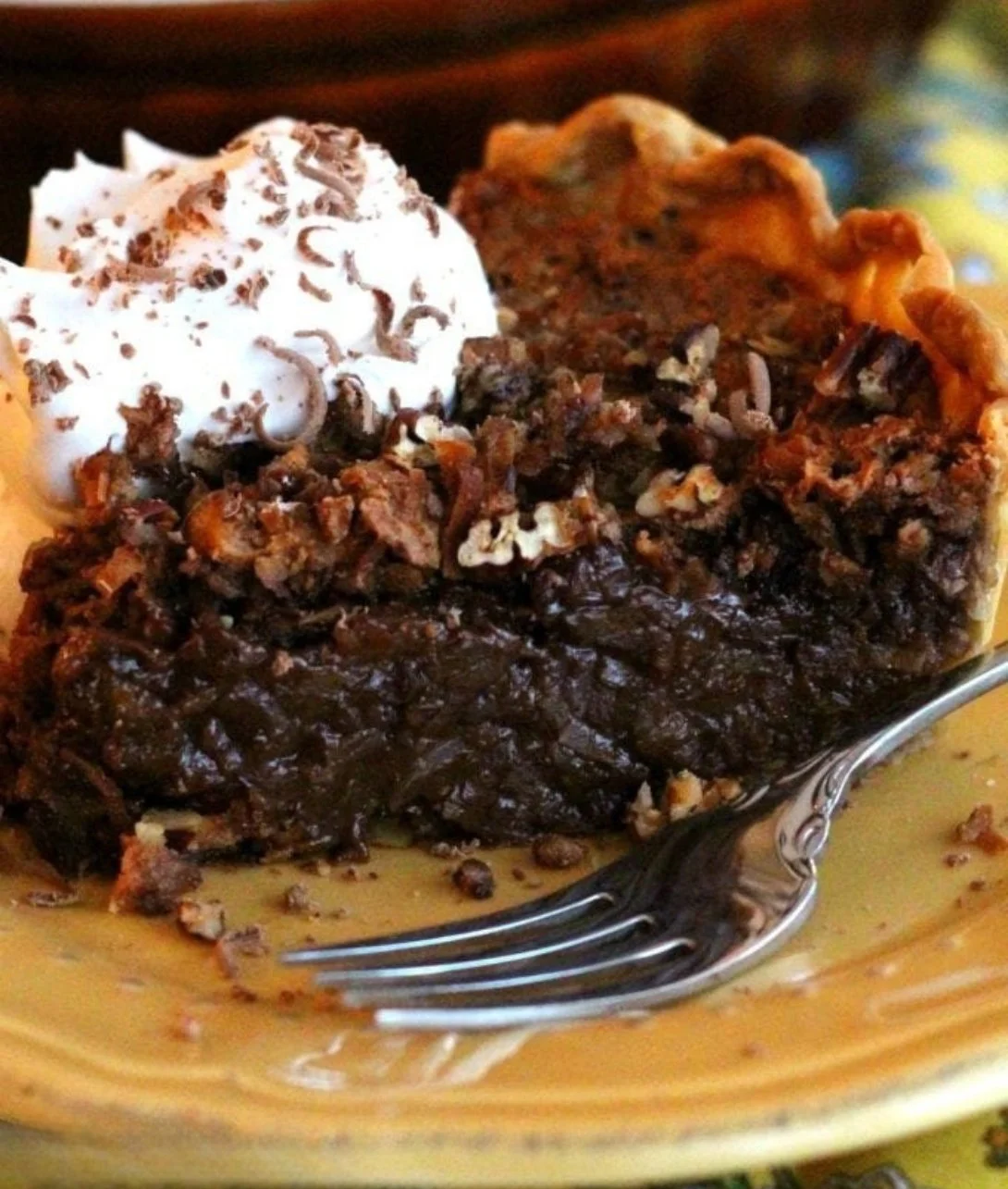 Homemade German Chocolate Pie topped with coconut and pecan filling