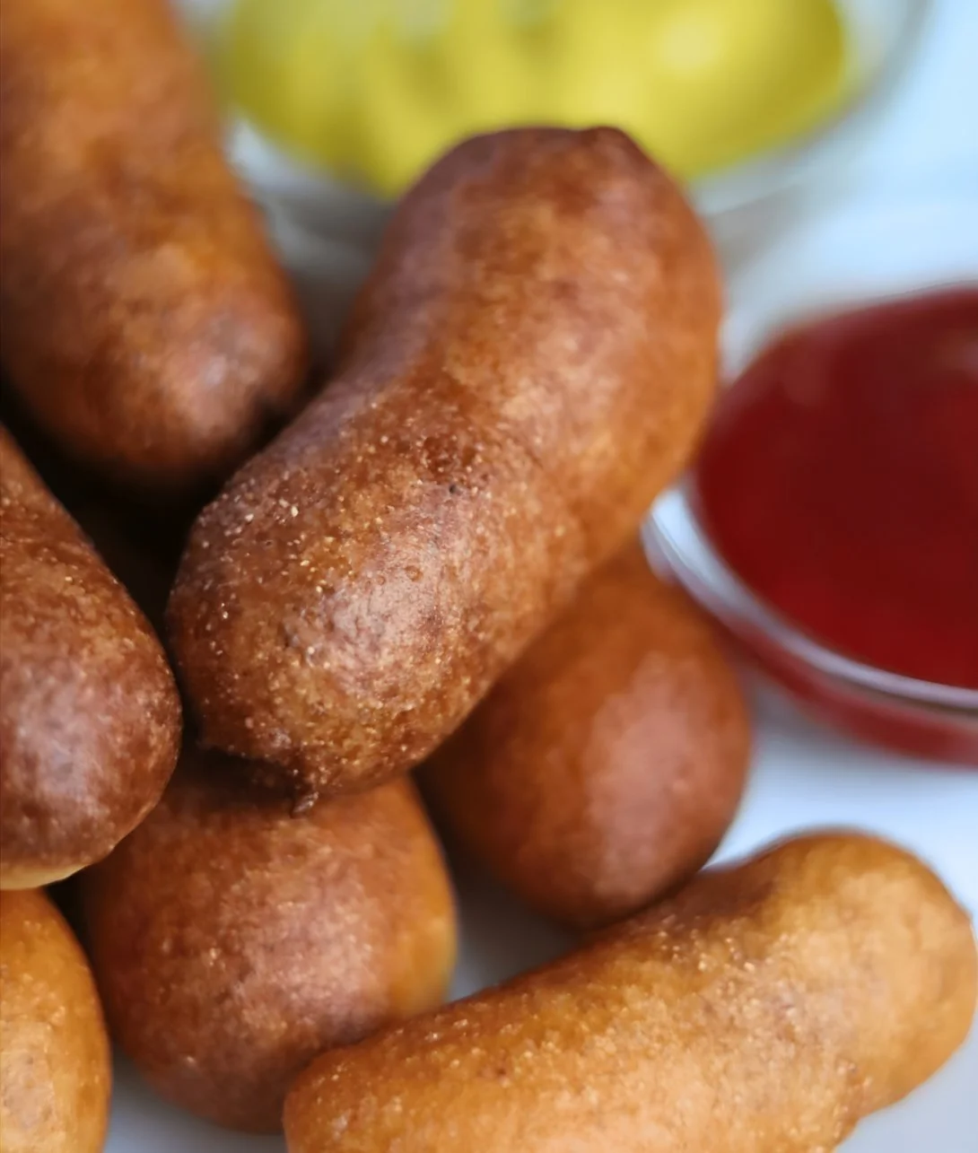 Delicious homemade sourdough mini corn dogs served with dipping sauce