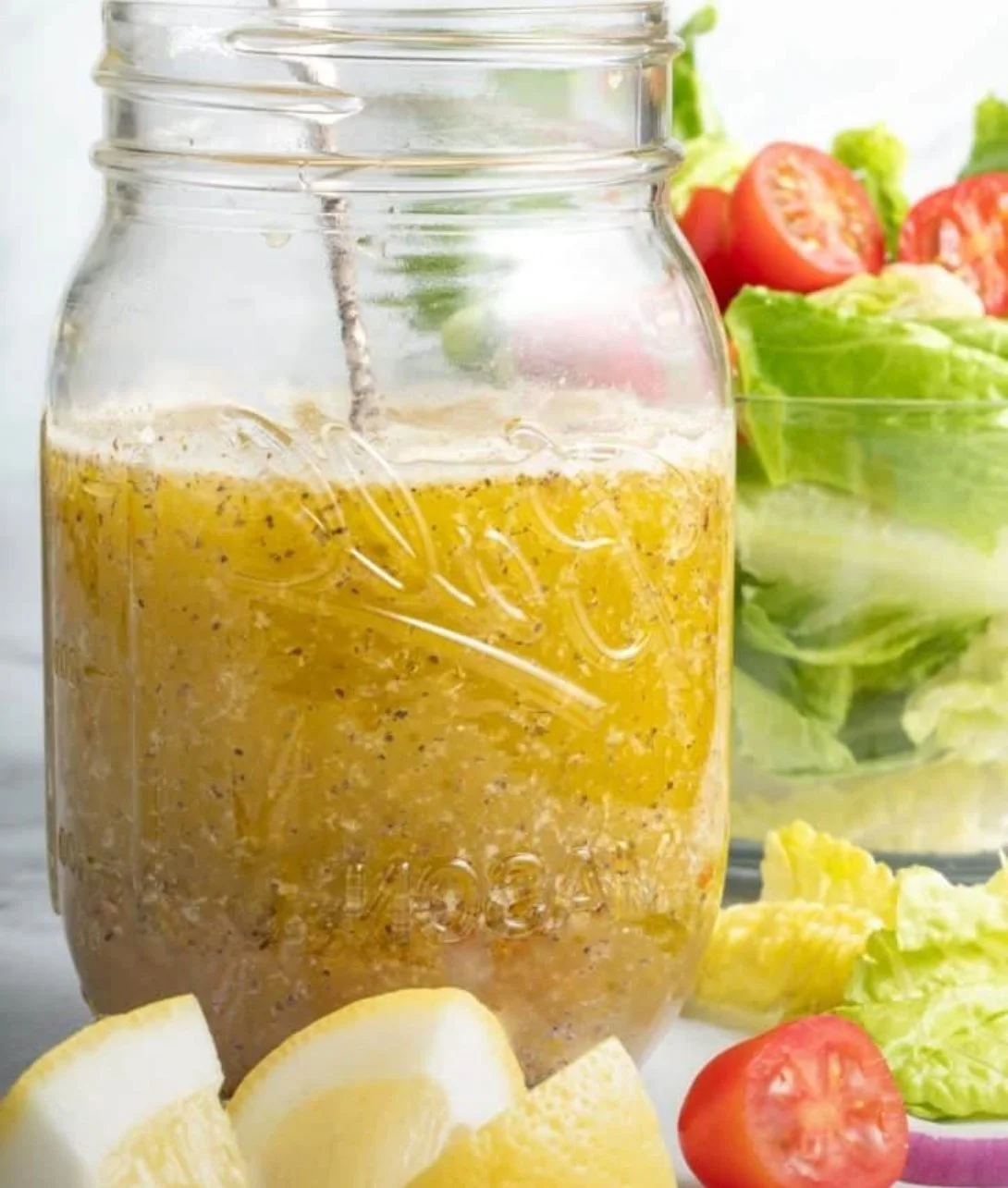 Bowl of homemade Mediterranean Salad Dressing with fresh herbs and spices