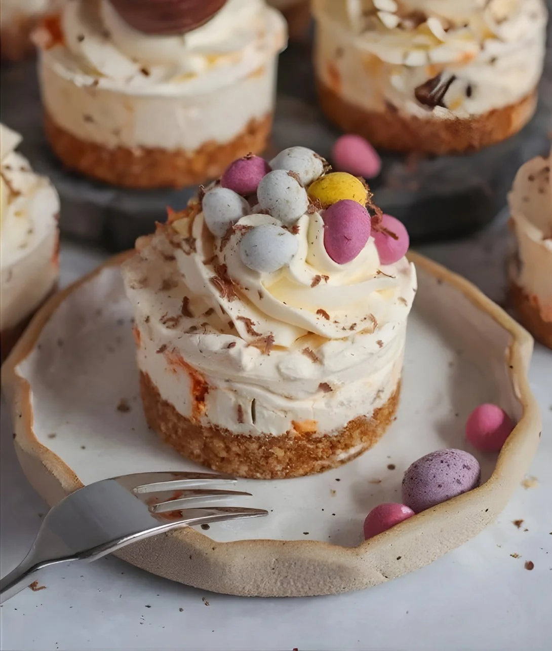 Mini Easter cheesecakes topped with colorful decorations and Easter eggs