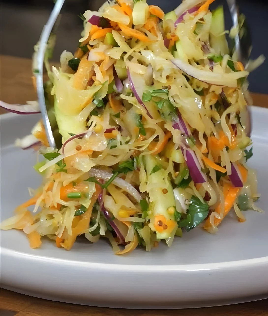 A vibrant bowl of Old Fashioned Sauerkraut Salad with fresh vegetables.