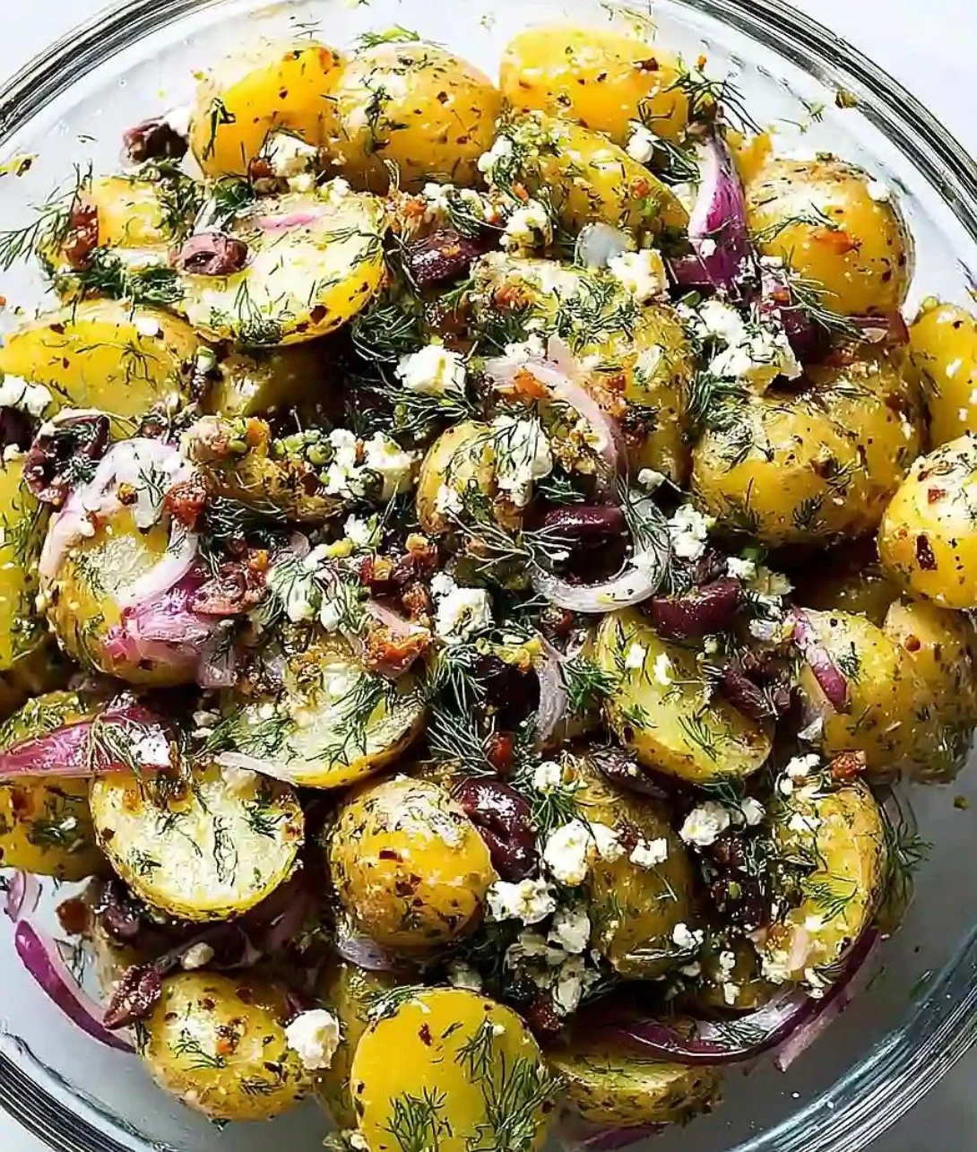 Bowl of Olive Greek Potato Salad with colorful vegetables and olives