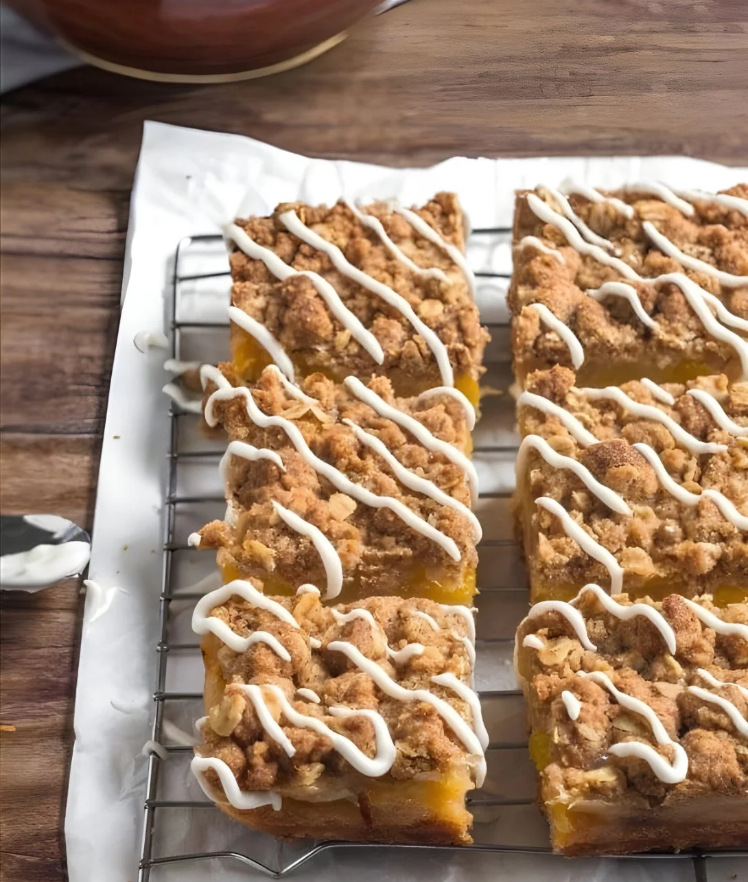 Peach Pie Crumble Bars topped with a golden crumble and fresh peaches