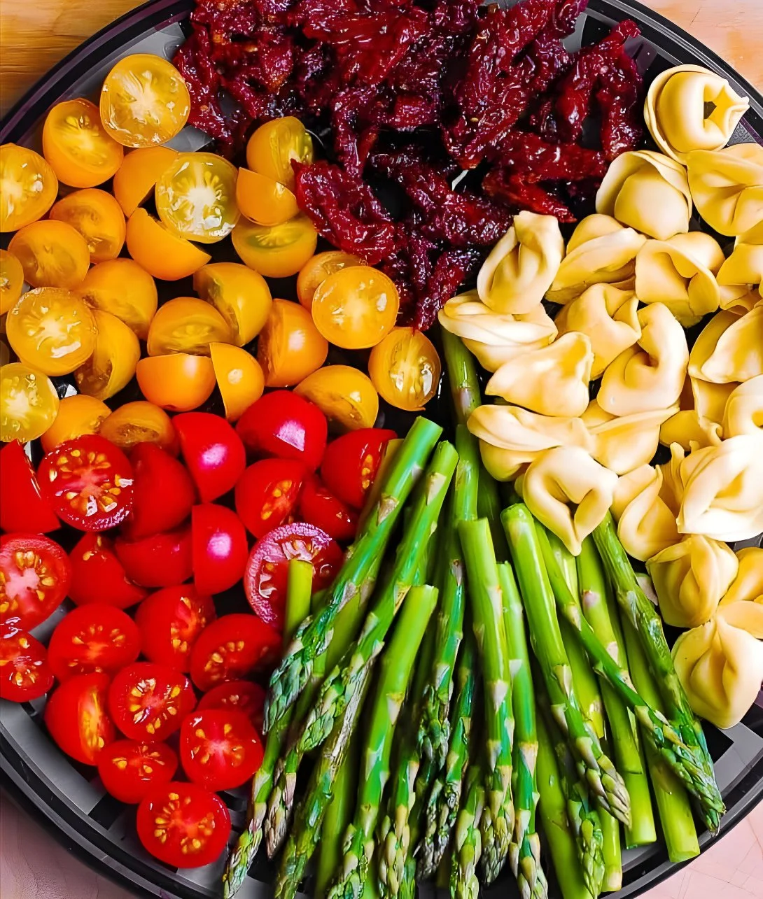 Pesto Chicken Tortellini with fresh vegetables in a bowl