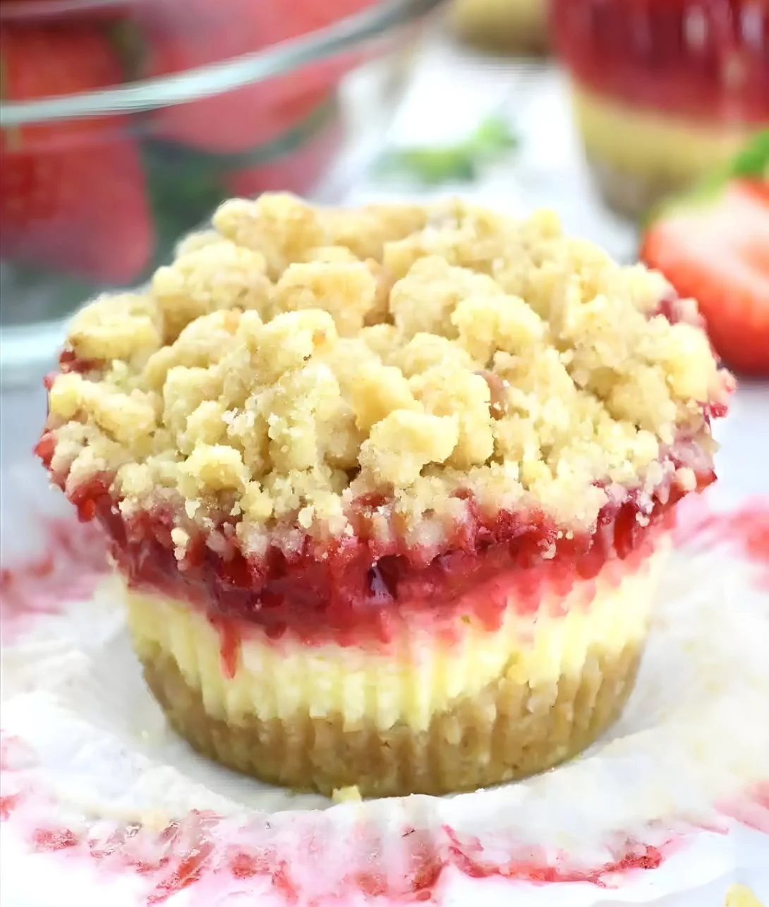 Baked strawberry cheesecake cupcakes with streusel crunch topping