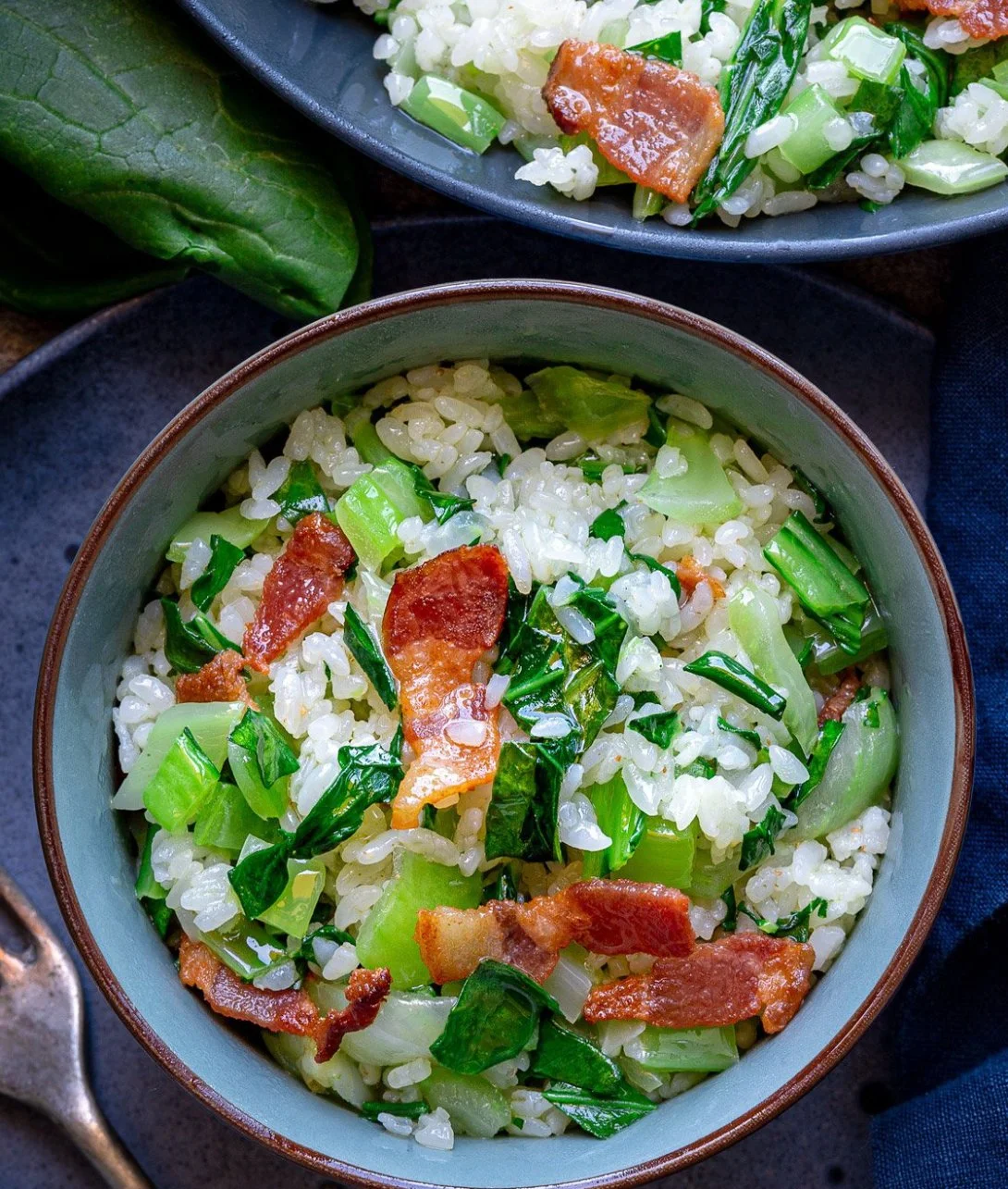 A delicious plate of Bok Choy Fried Rice with crispy bacon and colorful vegetables.