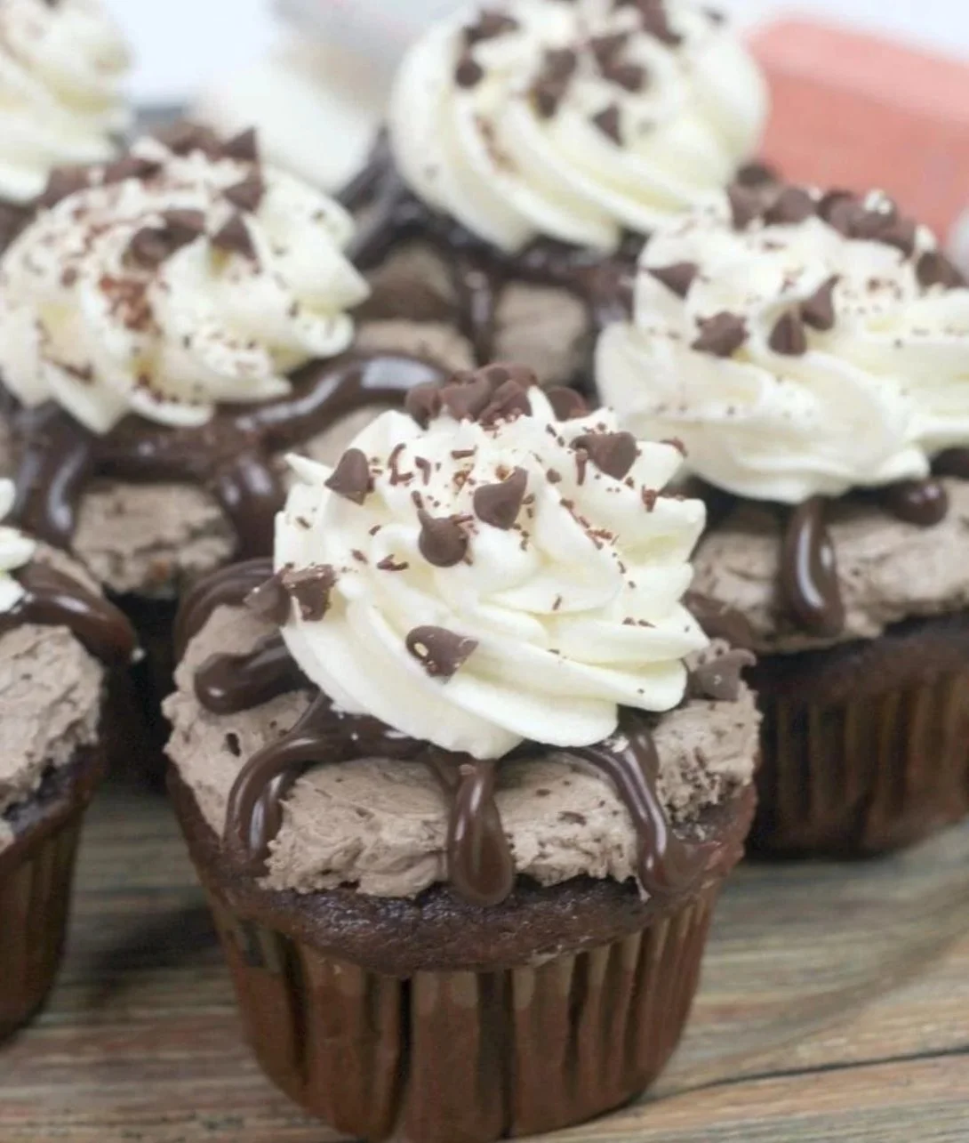 Delicious chocolate mousse cupcakes topped with chocolate frosting and sprinkles
