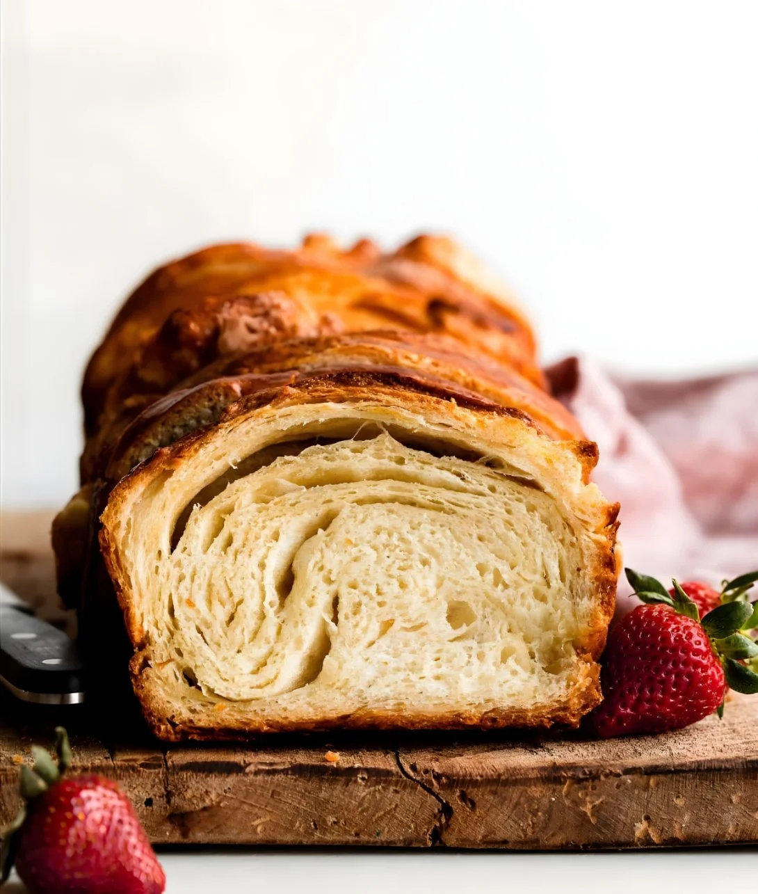 Freshly baked croissant bread showcasing flaky layers and golden crust.