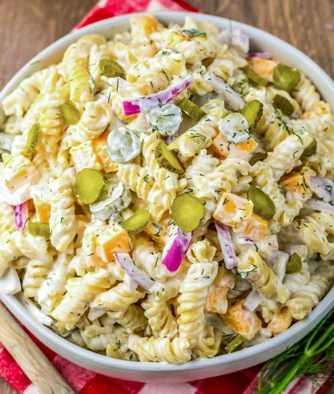 Delicious Dill Pickle Pasta Salad served in a bowl with fresh herbs