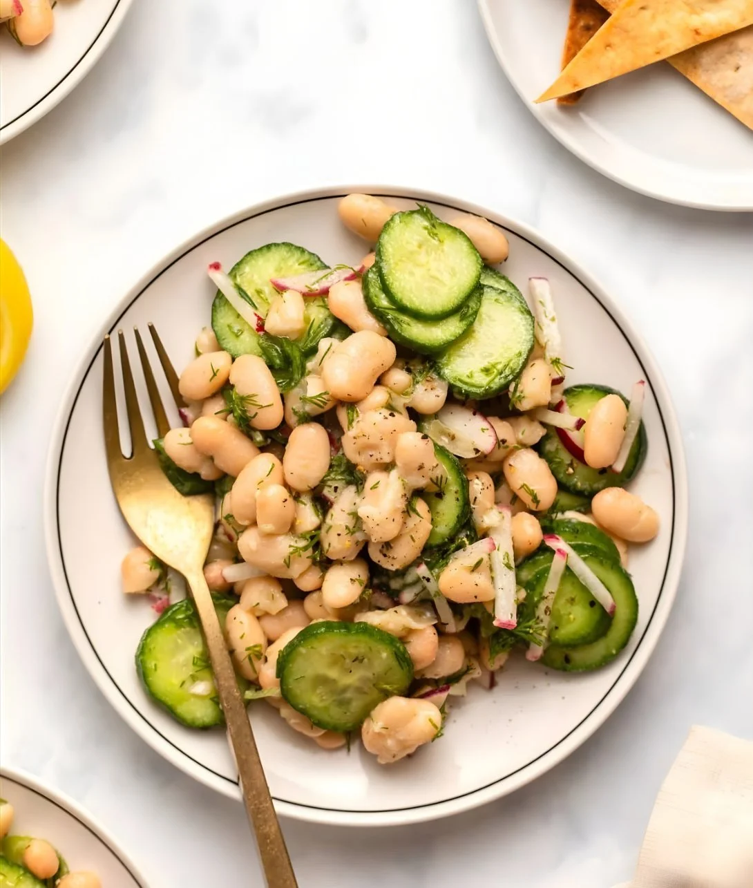 Dilly white bean cucumber salad served in a bowl with fresh ingredients