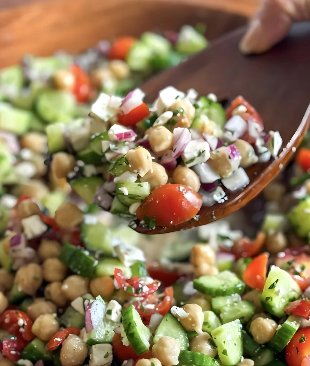 A vibrant chickpea cucumber salad with fresh vegetables and dressing.