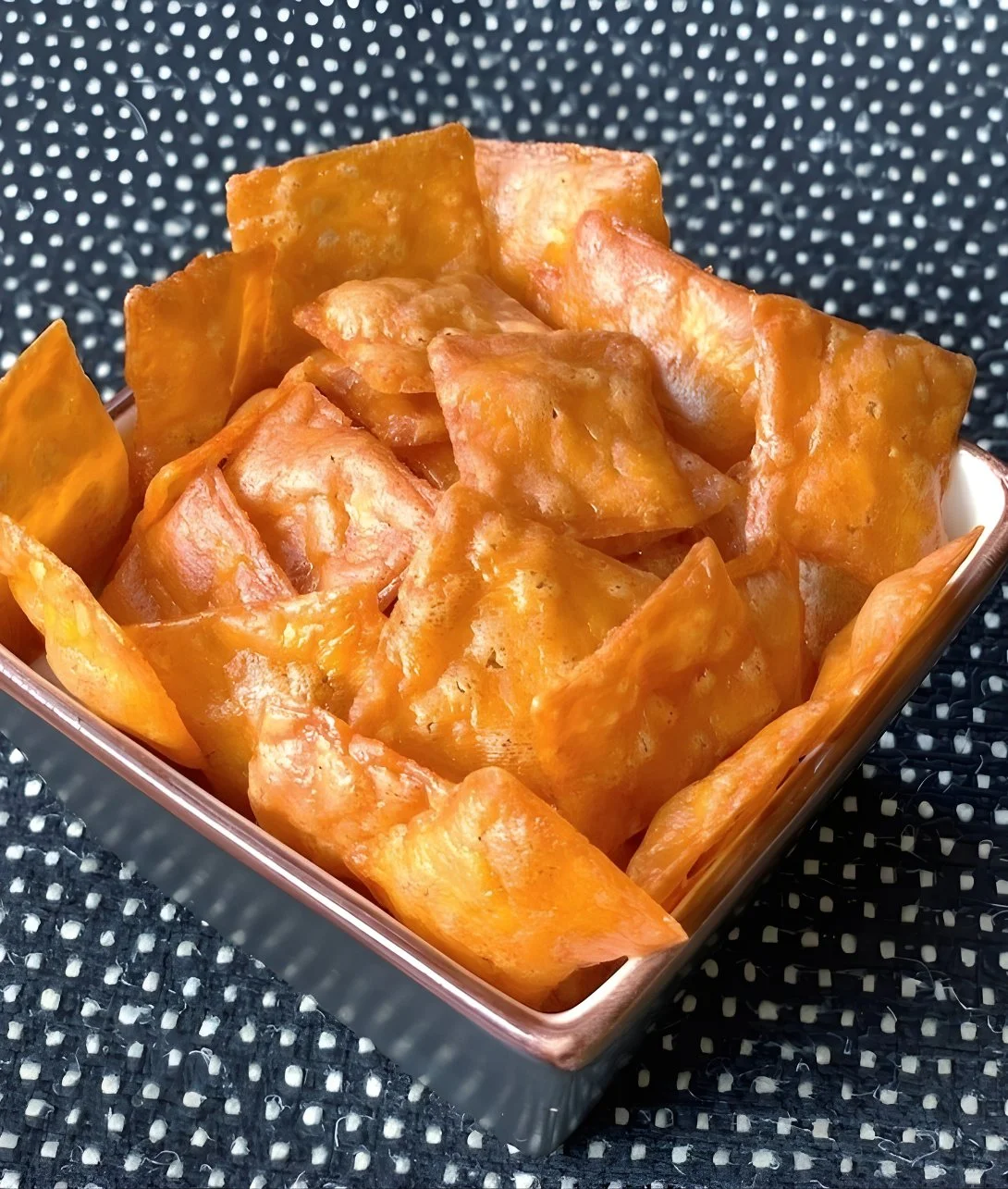 Easy homemade Keto Cheez-It Crackers on a wooden board.