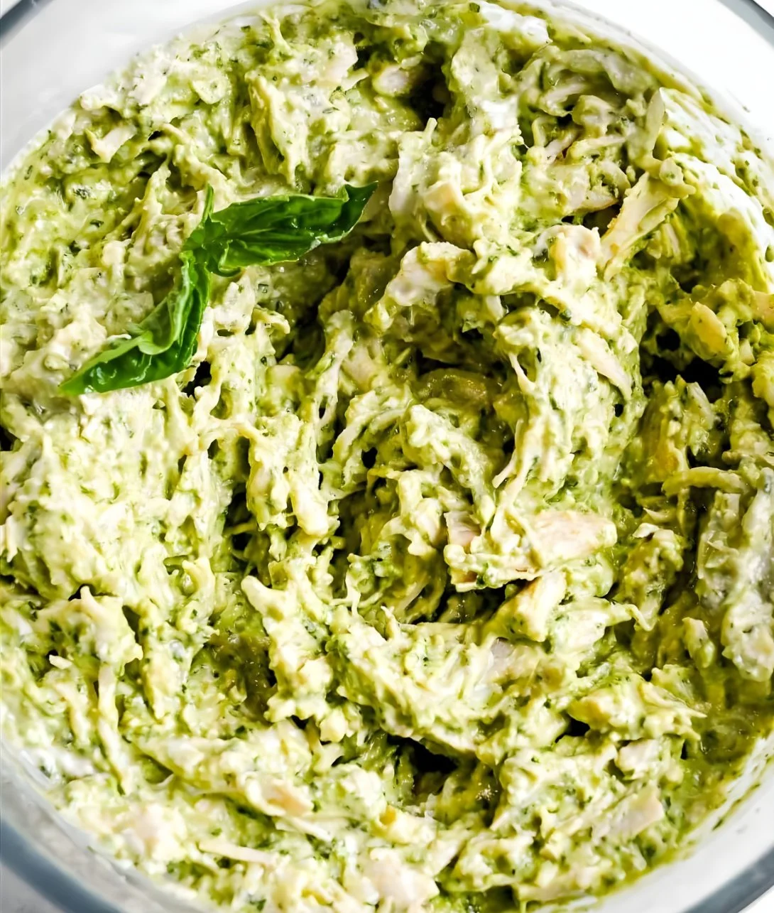 Delicious and easy pesto chicken salad with fresh ingredients in a bowl