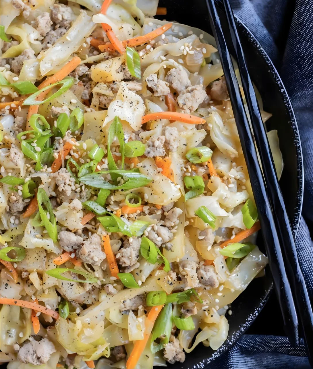 Delicious egg roll in a bowl served with fresh vegetables and savory sauce