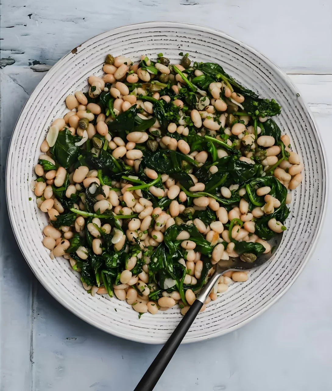 Delicious Garlic Spinach and White Beans dish served in a bowl.
