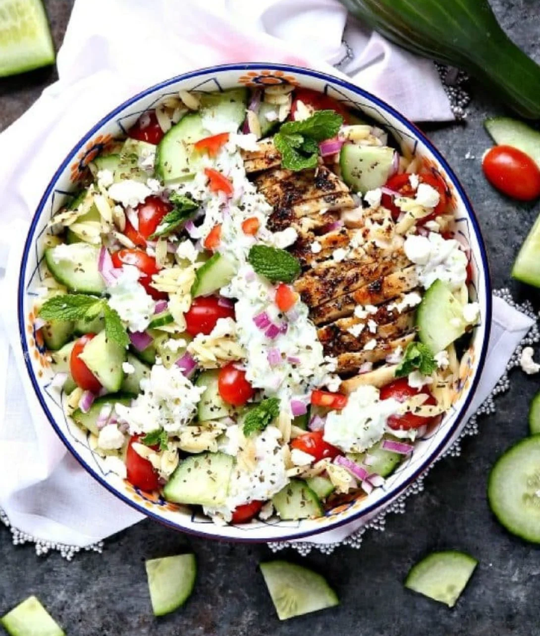 Delicious Greek Chicken Orzo Power Bowls with fresh vegetables and herbs