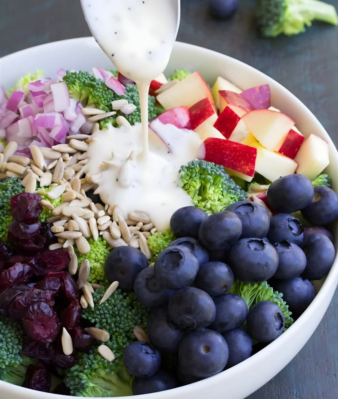 Healthy broccoli salad with fresh vegetables and dressing