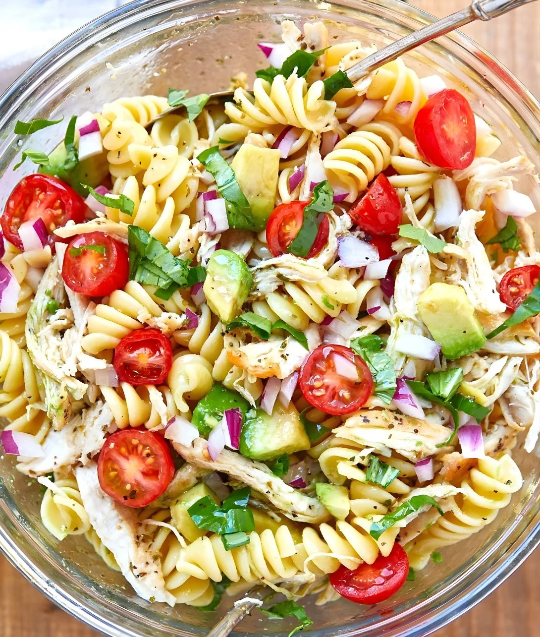 Healthy chicken pasta salad with avocado and fresh vegetables