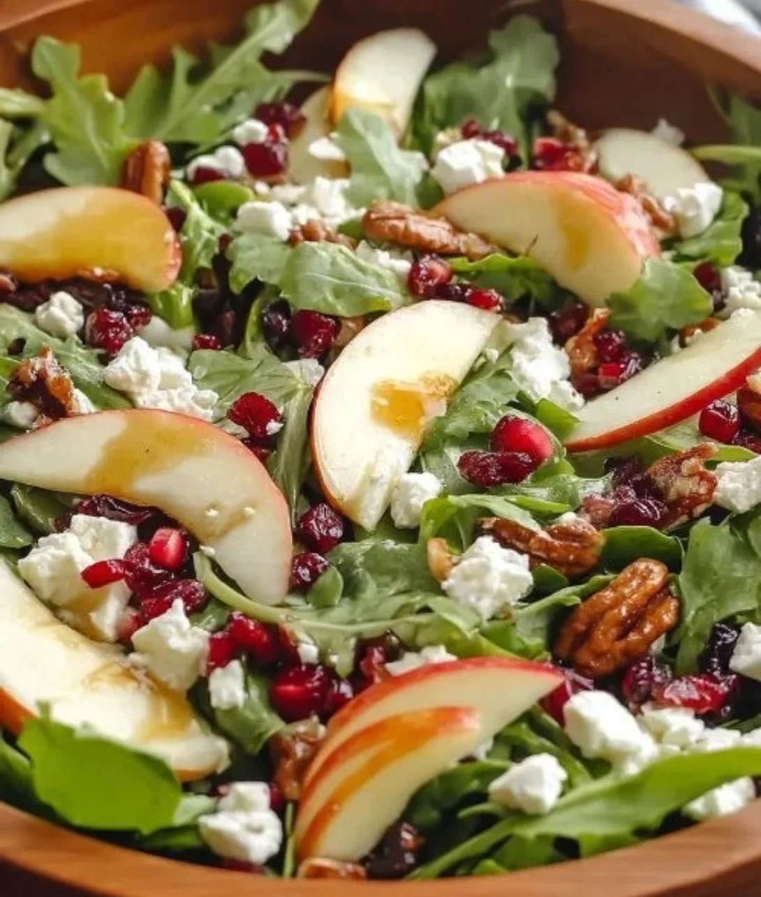 Honeycrisp apple and feta salad in a bowl with greens and nuts