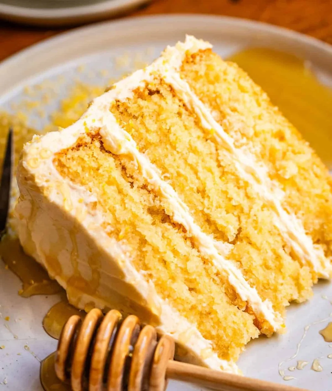 Layered cornbread cake topped with cream and fresh berries