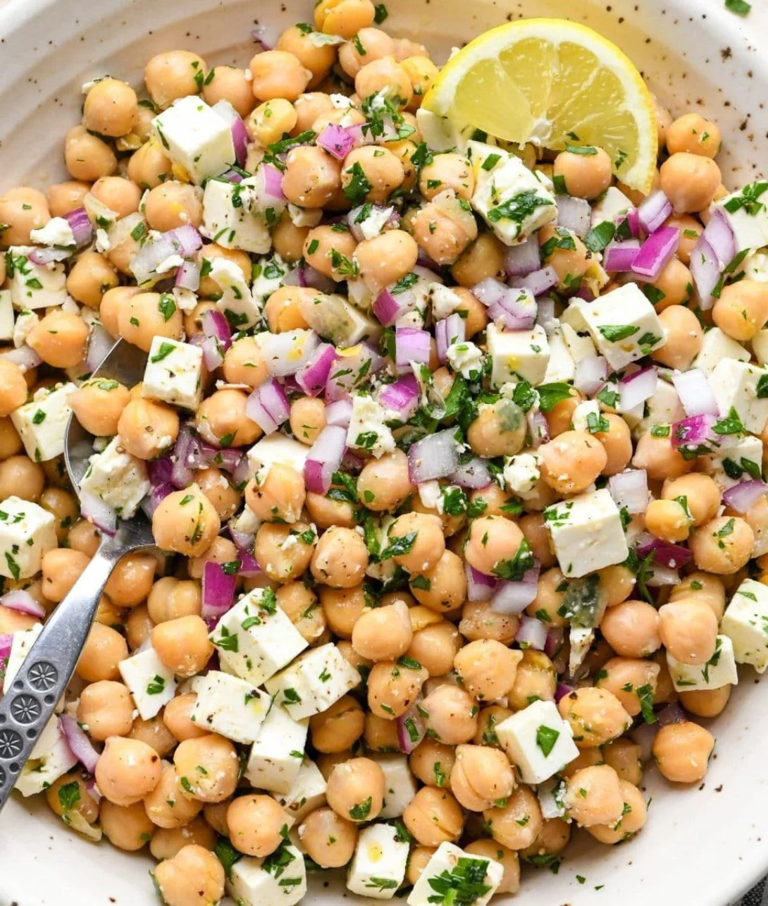A vibrant Lemony Chickpea Feta Salad with fresh ingredients and zesty dressing.