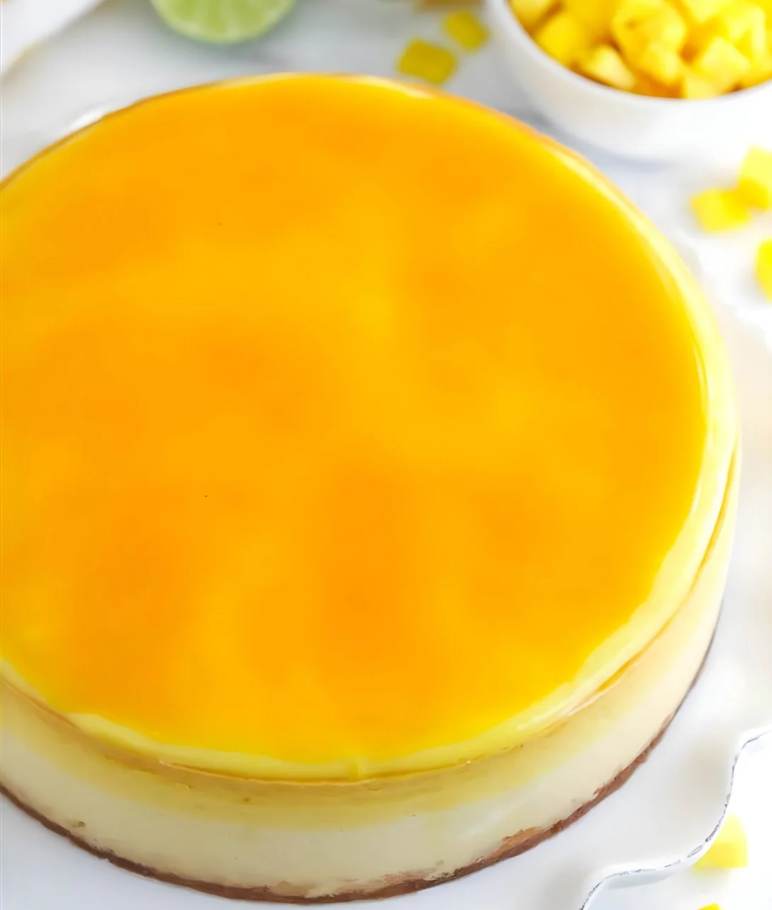 Delicious slice of Mango Key Lime Cheesecake topped with fresh mango slices