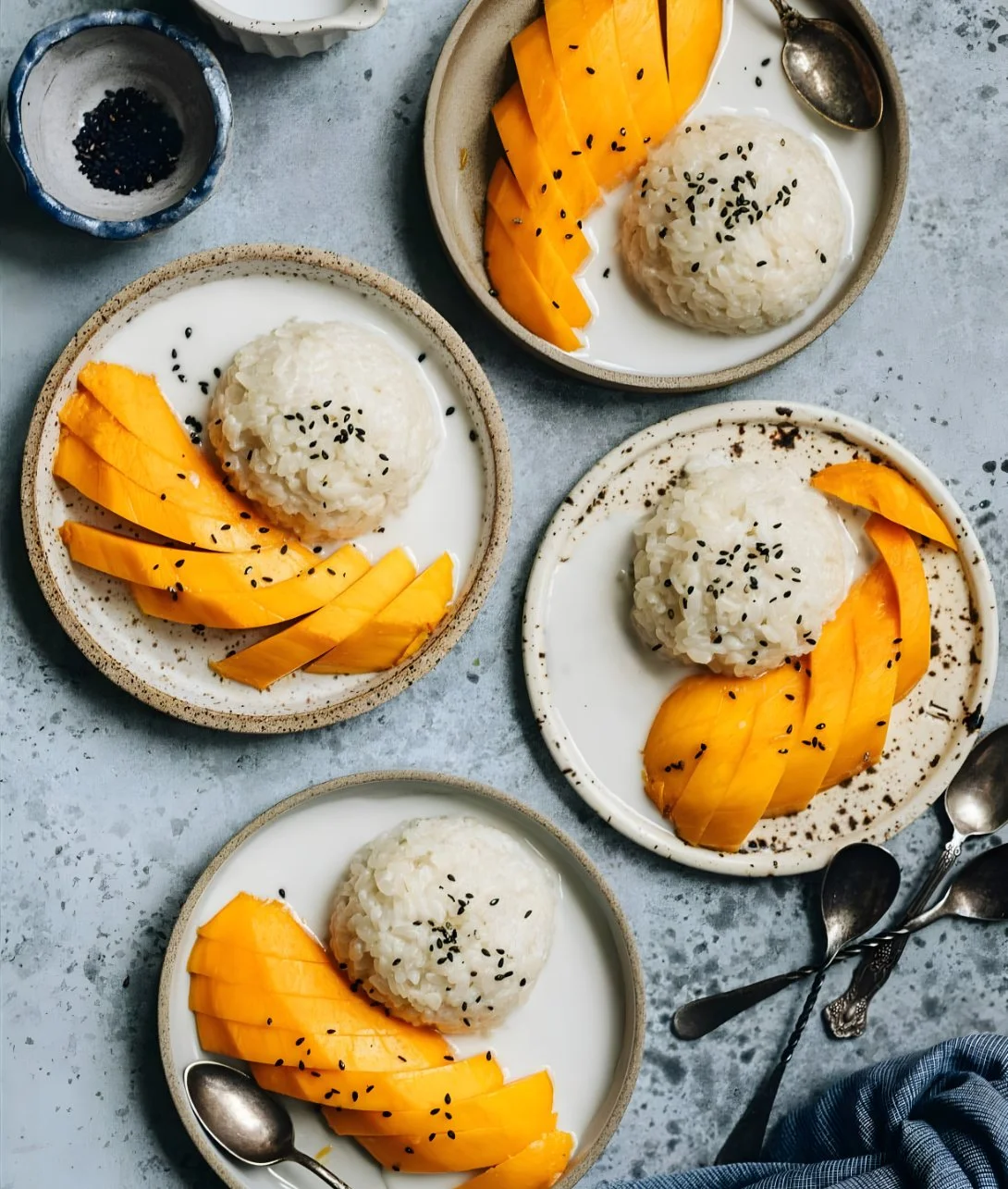 Delicious mango sticky rice dessert with fresh mango and coconut sauce served on a plate.