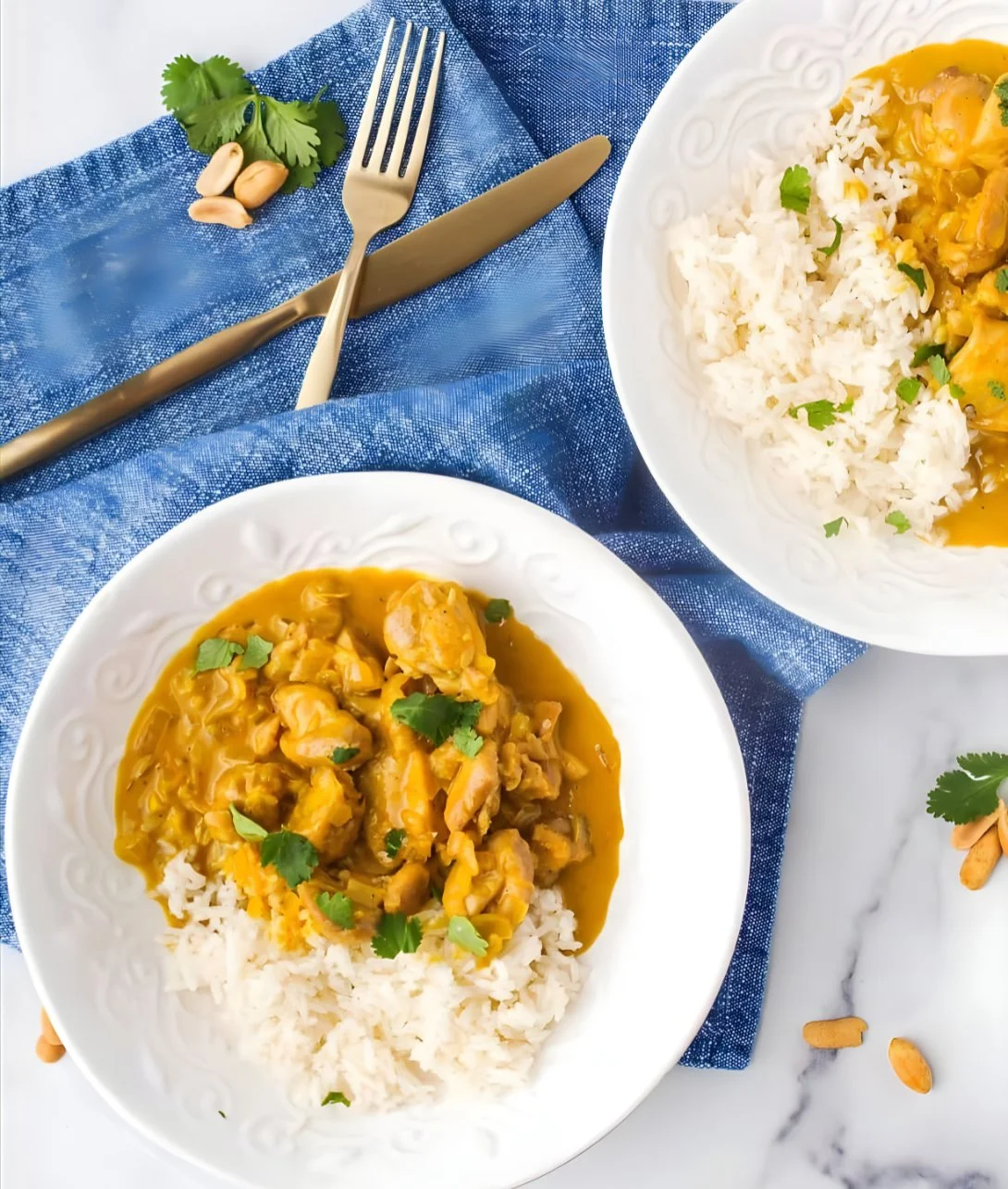 A bowl of creamy Peanut Butter Chicken Curry garnished with fresh cilantro.