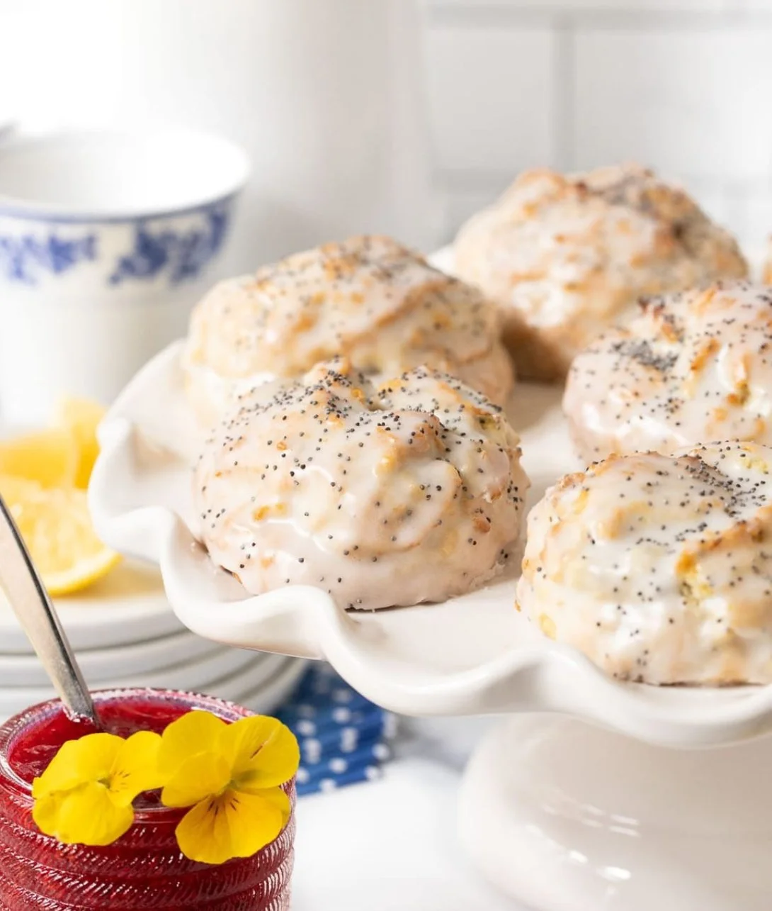 Delicious lemon poppy seed scones on a table with fresh lemons