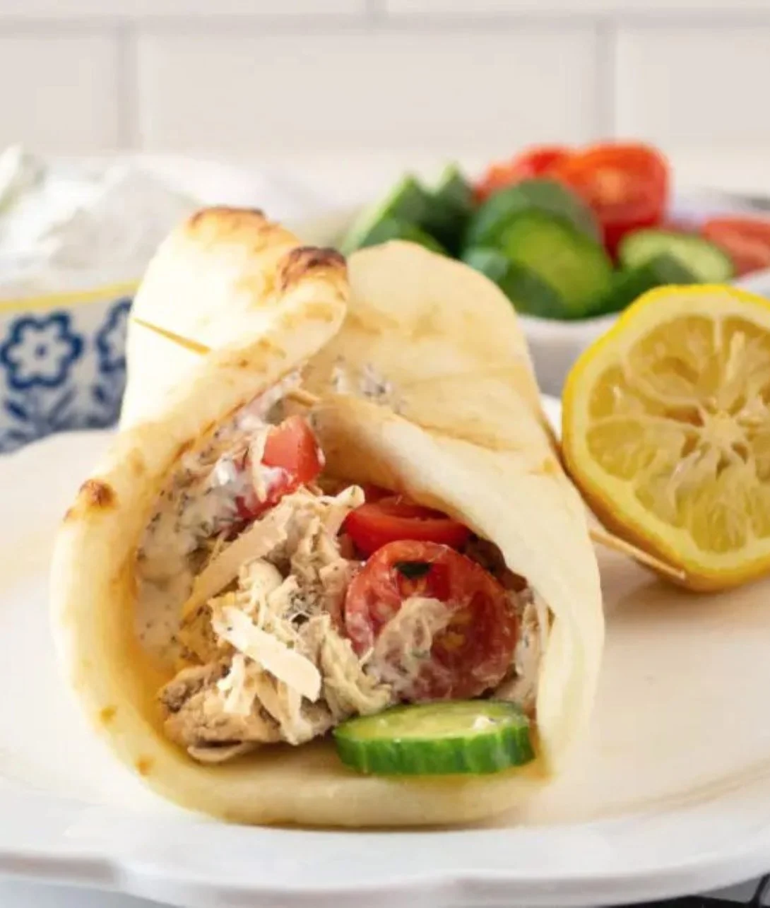 Slow cooker chicken gyros served with fresh veggies and tzatziki sauce