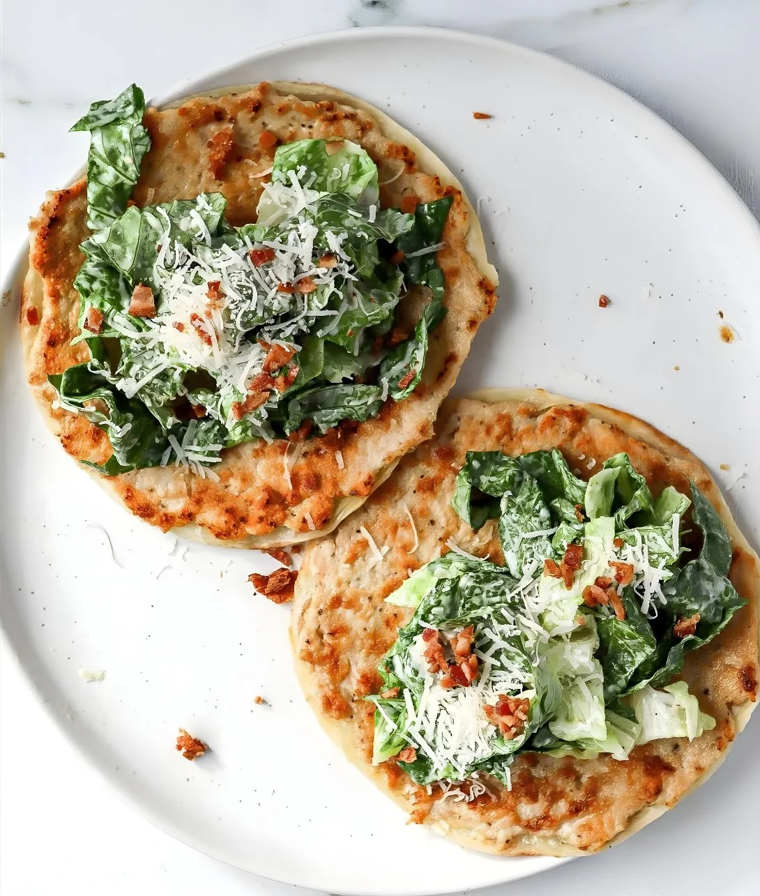 Delicious Smash Chicken Caesar Tacos garnished with Romaine lettuce and Caesar dressing