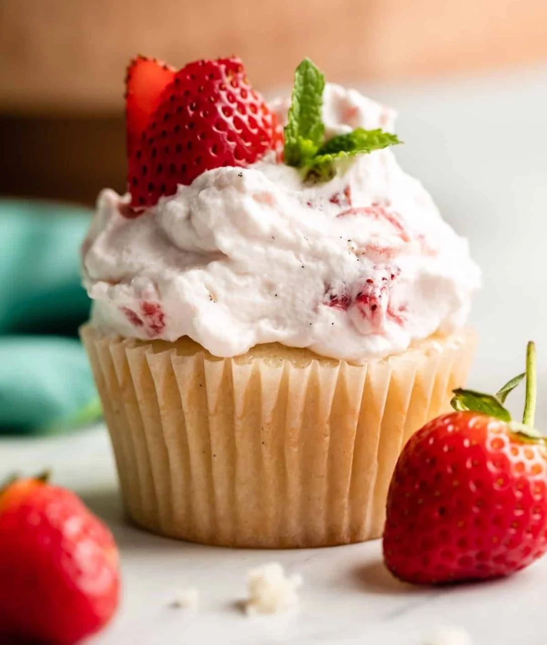Delicious strawberry shortcake cupcakes topped with fresh strawberries and whipped cream