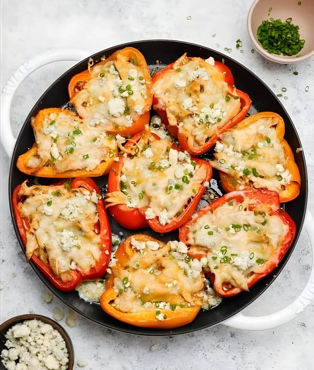 Stuffed bell peppers filled with buffalo chicken, garnished and ready to serve.