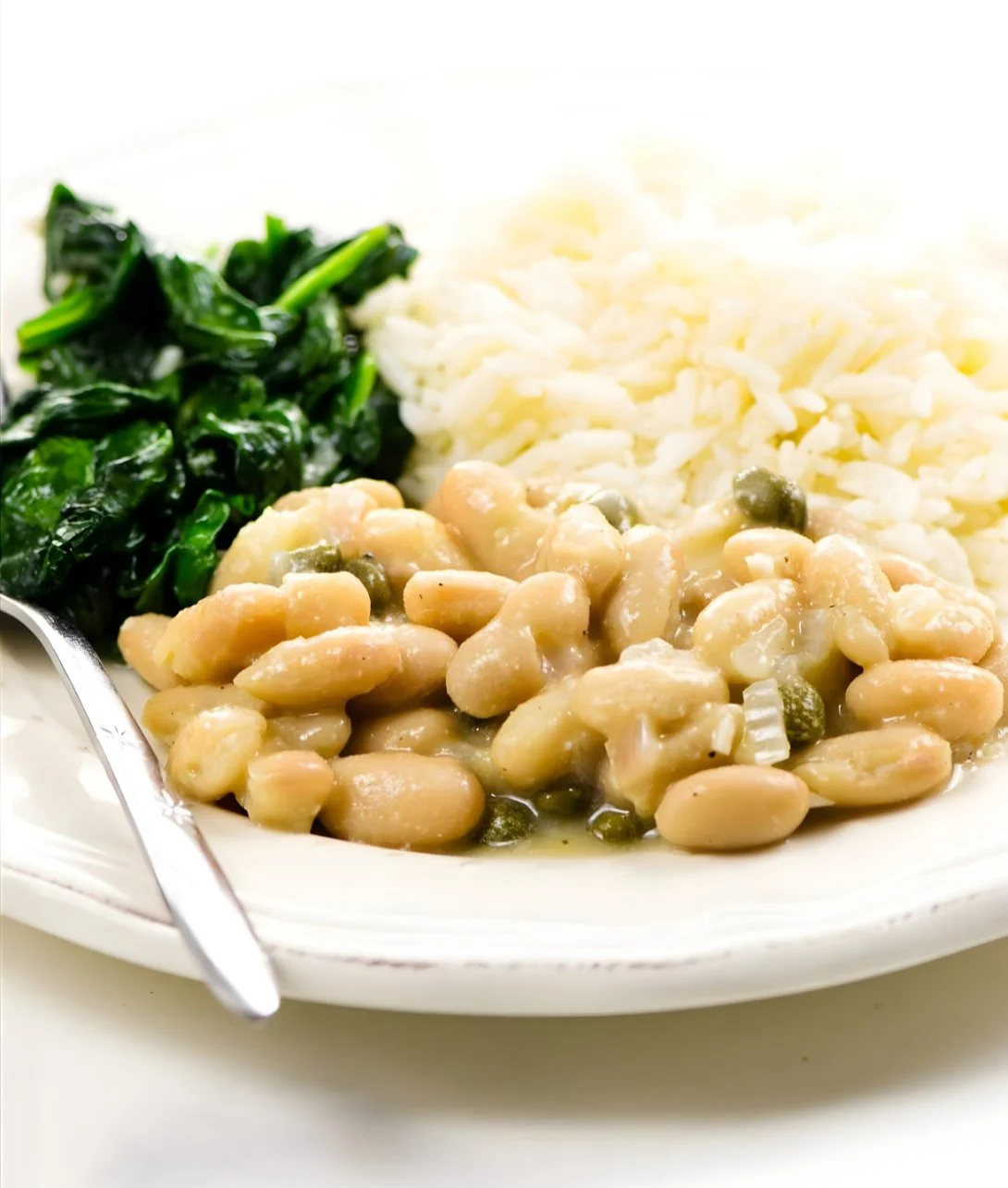 Vegetarian Piccata with cannellini beans served on a plate with herbs