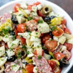 Colorful Antipasto Salad with fresh vegetables, meats, and cheeses
