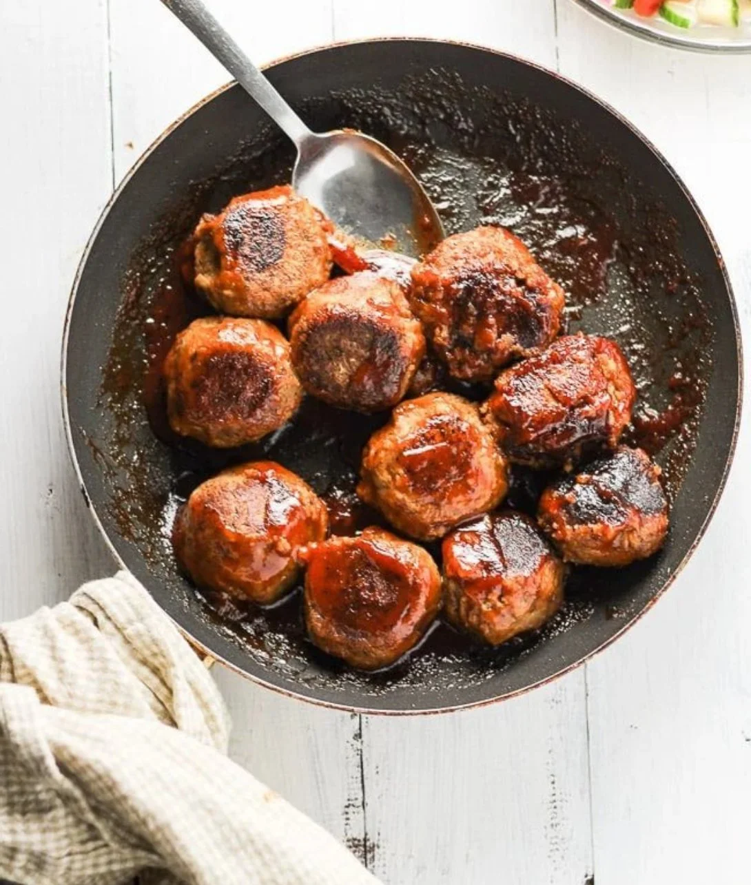BBQ vegan lentil meatballs served on a plate with fresh herbs