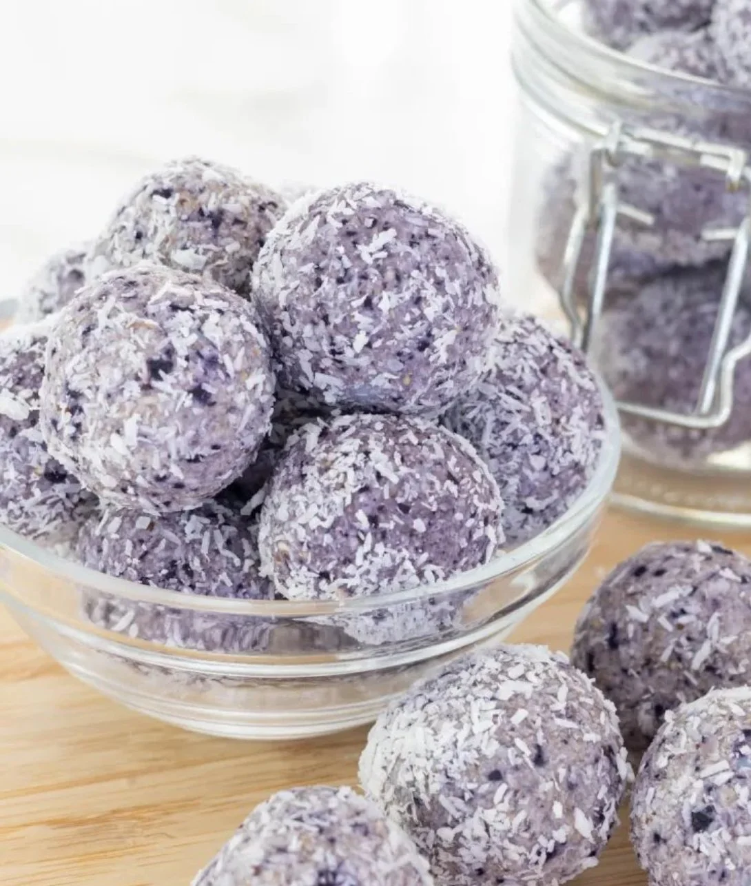 Homemade blueberry bliss balls on a wooden plate, healthy snack option