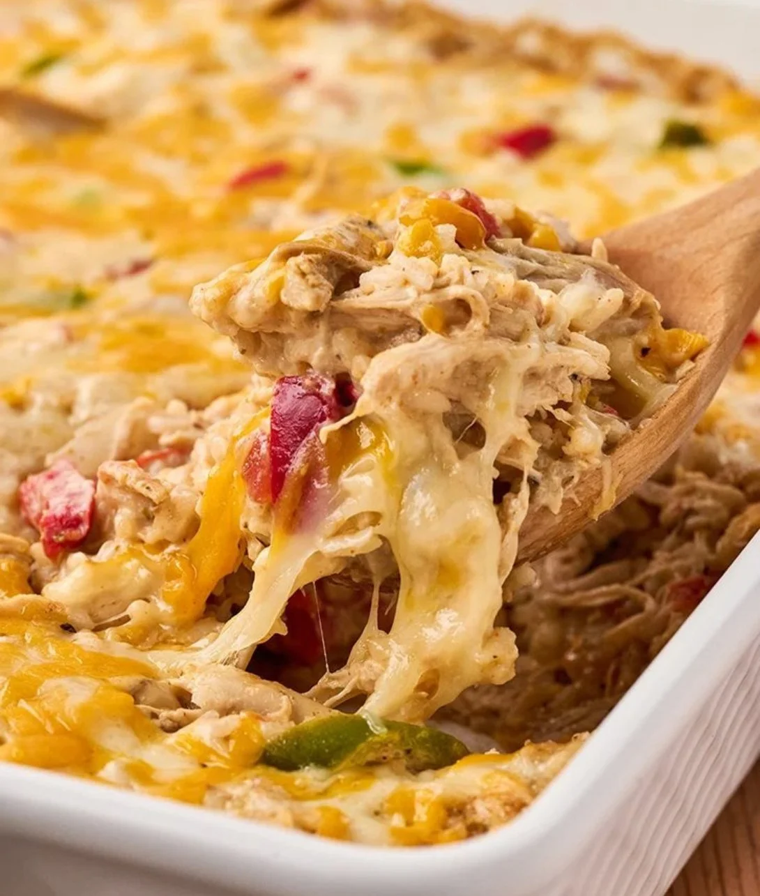 Baked Chicken Fajita Casserole topped with cheese and colorful bell peppers