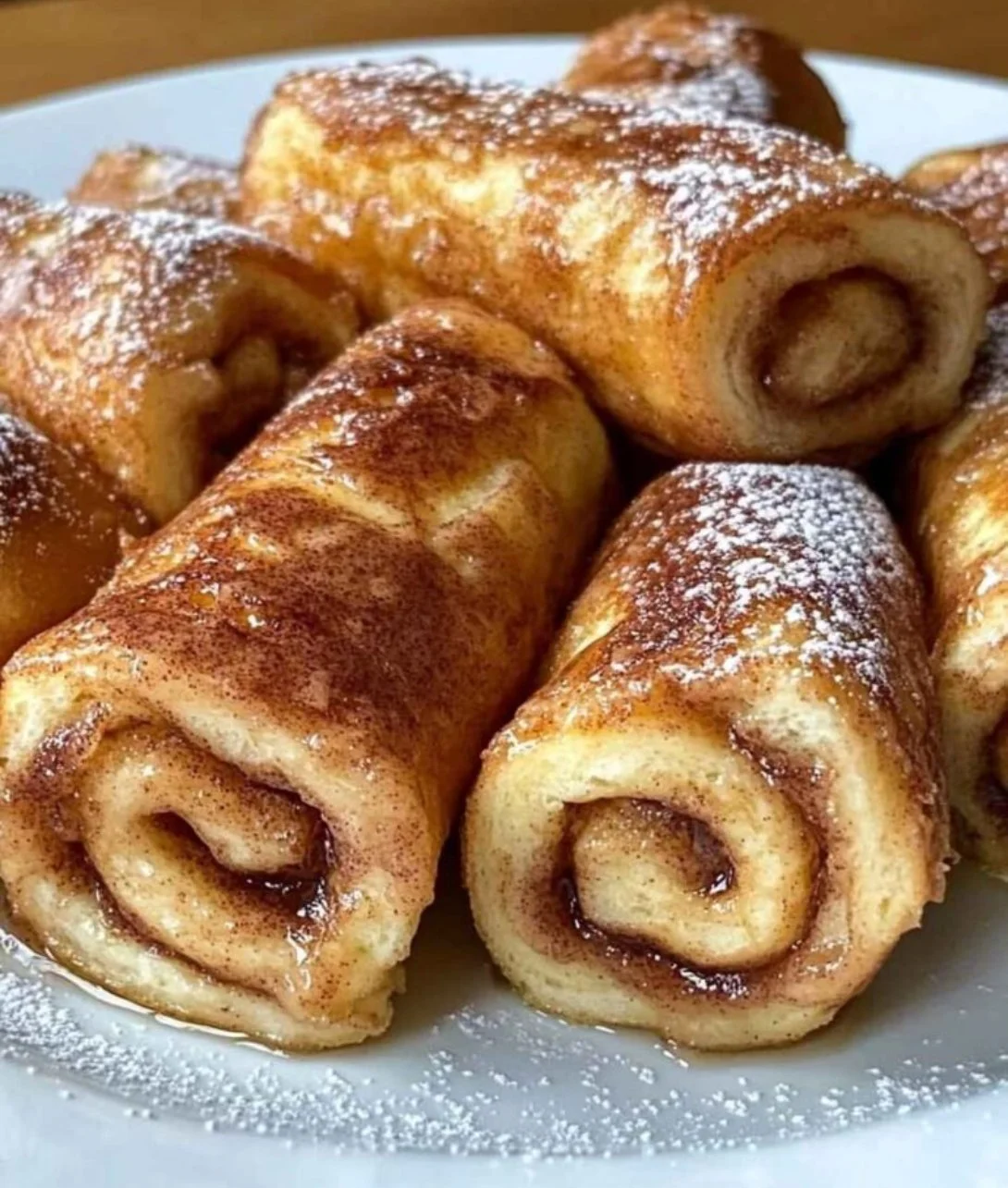 Delicious Cinnamon Roll French Toast Roll-Ups served on a plate