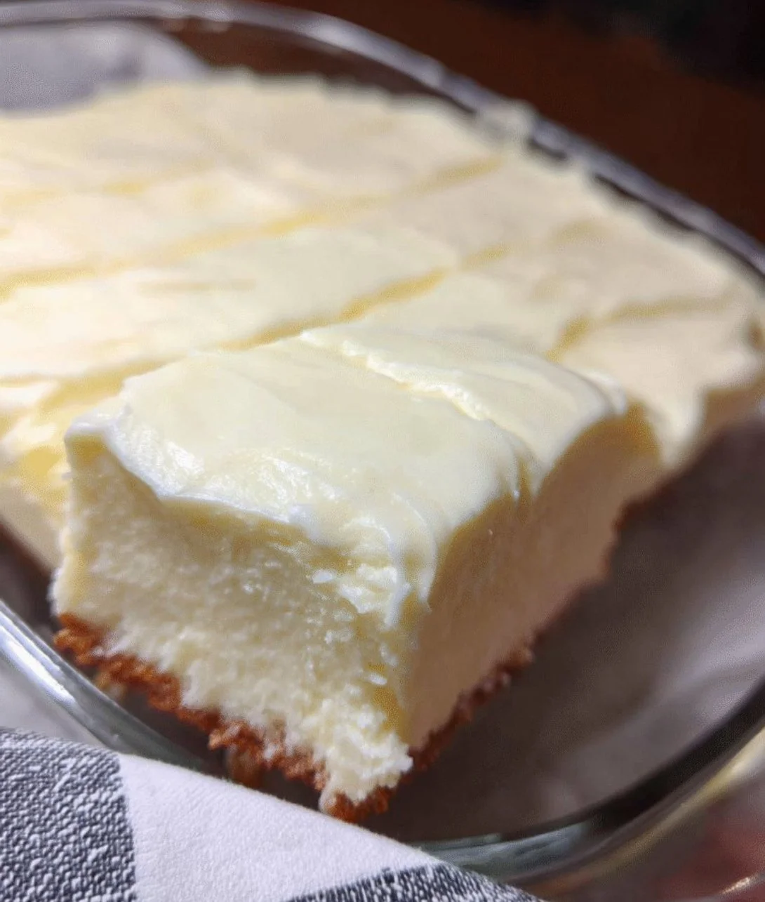 A slice of rich cream cheese cake topped with fresh berries and cream.