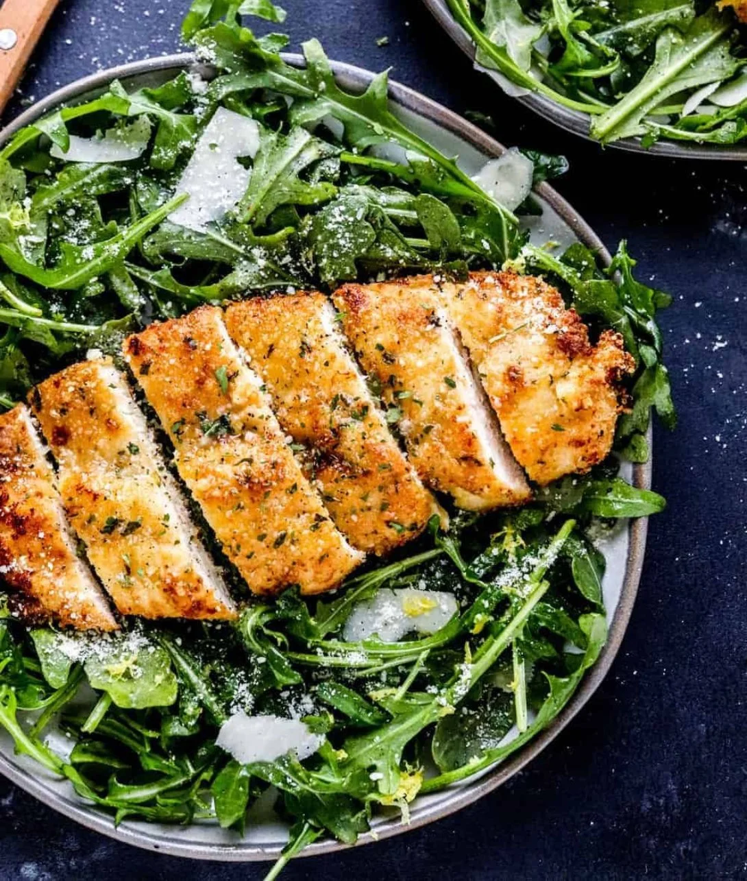 Crispy air fryer breaded chicken breast served with a side of vegetables