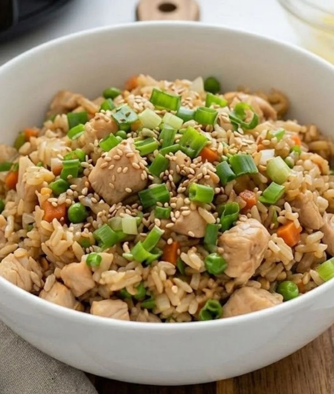 Crockpot chicken fried rice with colorful vegetables and chicken pieces