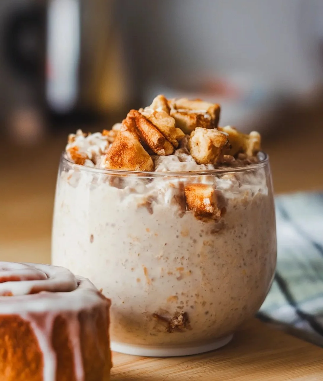 Freshly baked delicious cinnamon roll topped with creamy icing